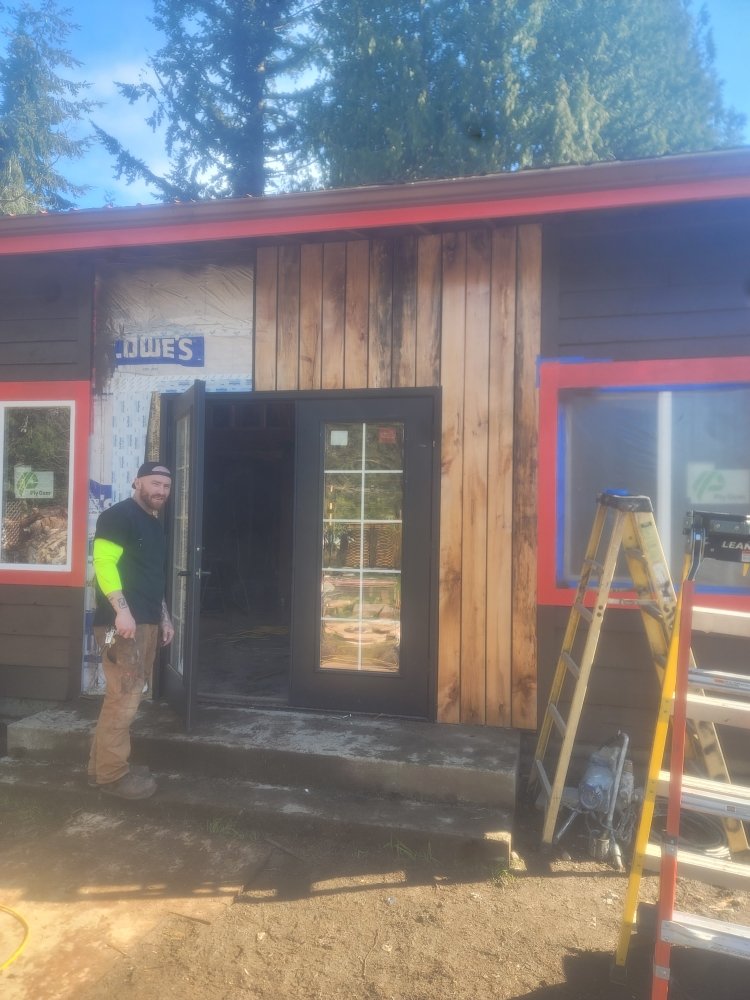 Cedar siding and new exterior door installed during a home remodel by Joyner Construction