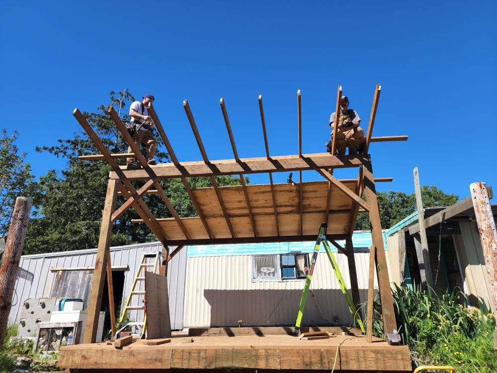 Timber-framed covered structure addition under construction